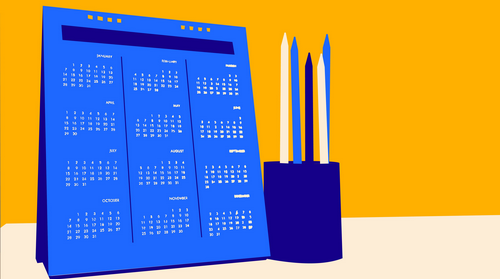 Calendrier posé sur une table à côté d'un pot de crayons